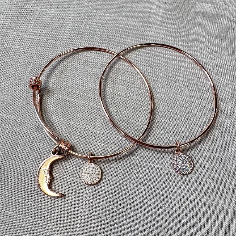 Two LA CN Rose Gold Tone Bangle Bracelets with Charms